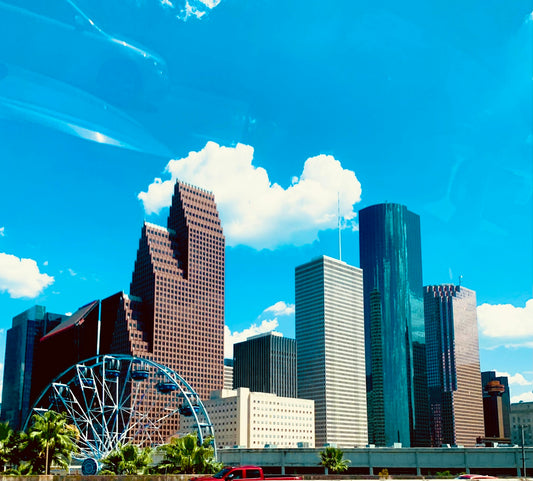 a city skyline with a ferris wheel in the foreground