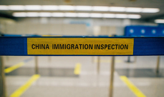 a yellow and blue sign that says china immigration inspection