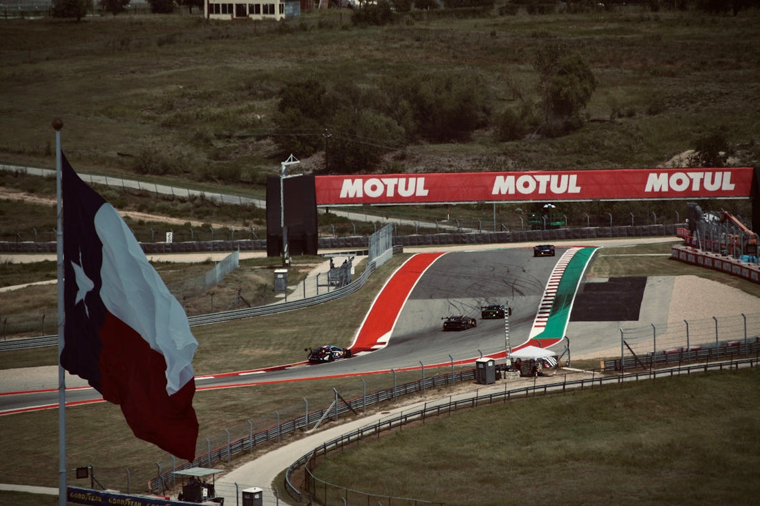 Formula 1 race cars speed along a track